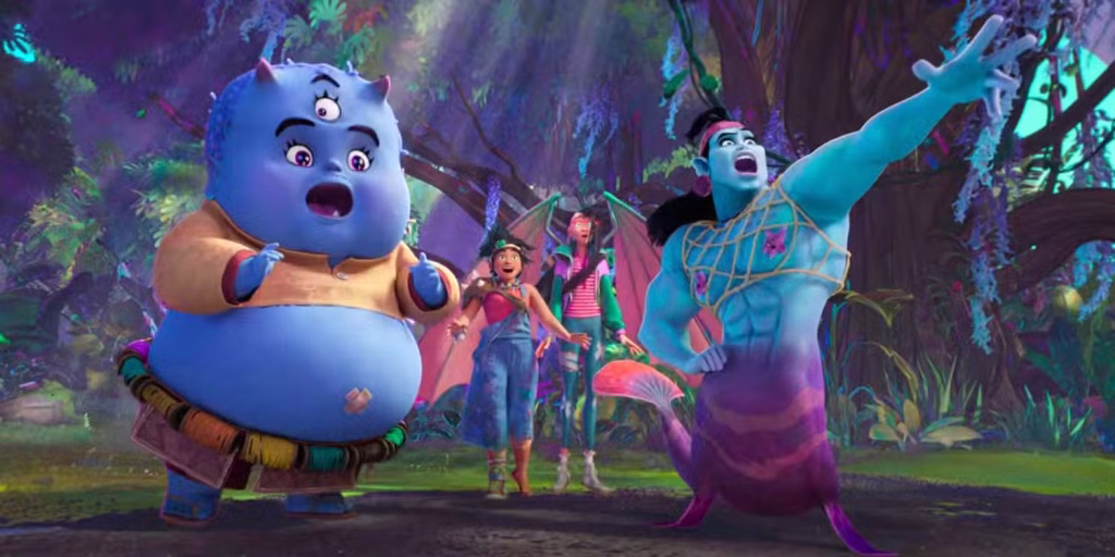 A group of brightly coloured animated fantasy creatures and characters standing together in a lush, glowing forest on Nakali, including a round blue creature and a tall blue mermaid-like figure.