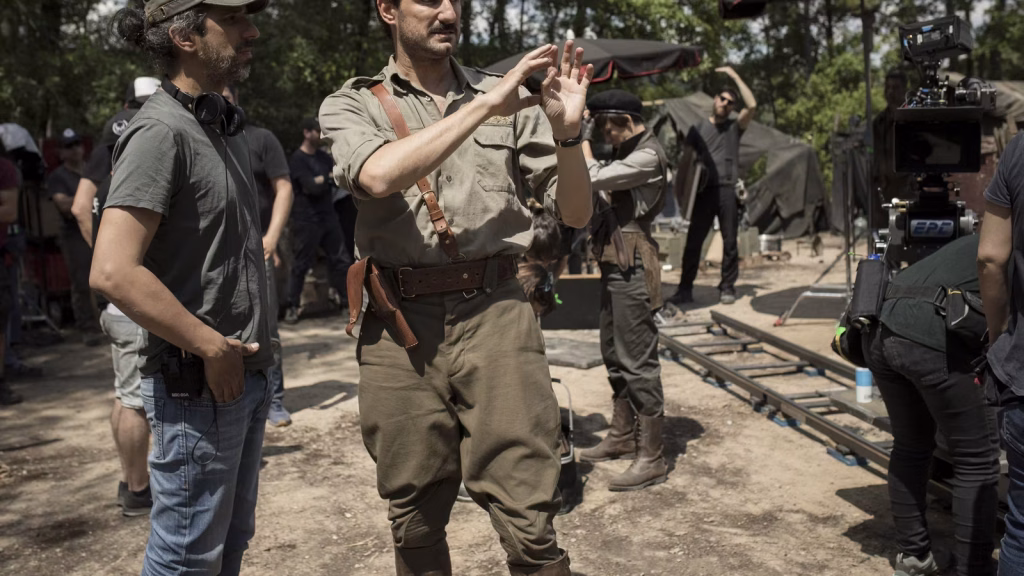 Behind-the-scenes view of the Malnazidos crew working on a forest sequence with period-costumed performers.