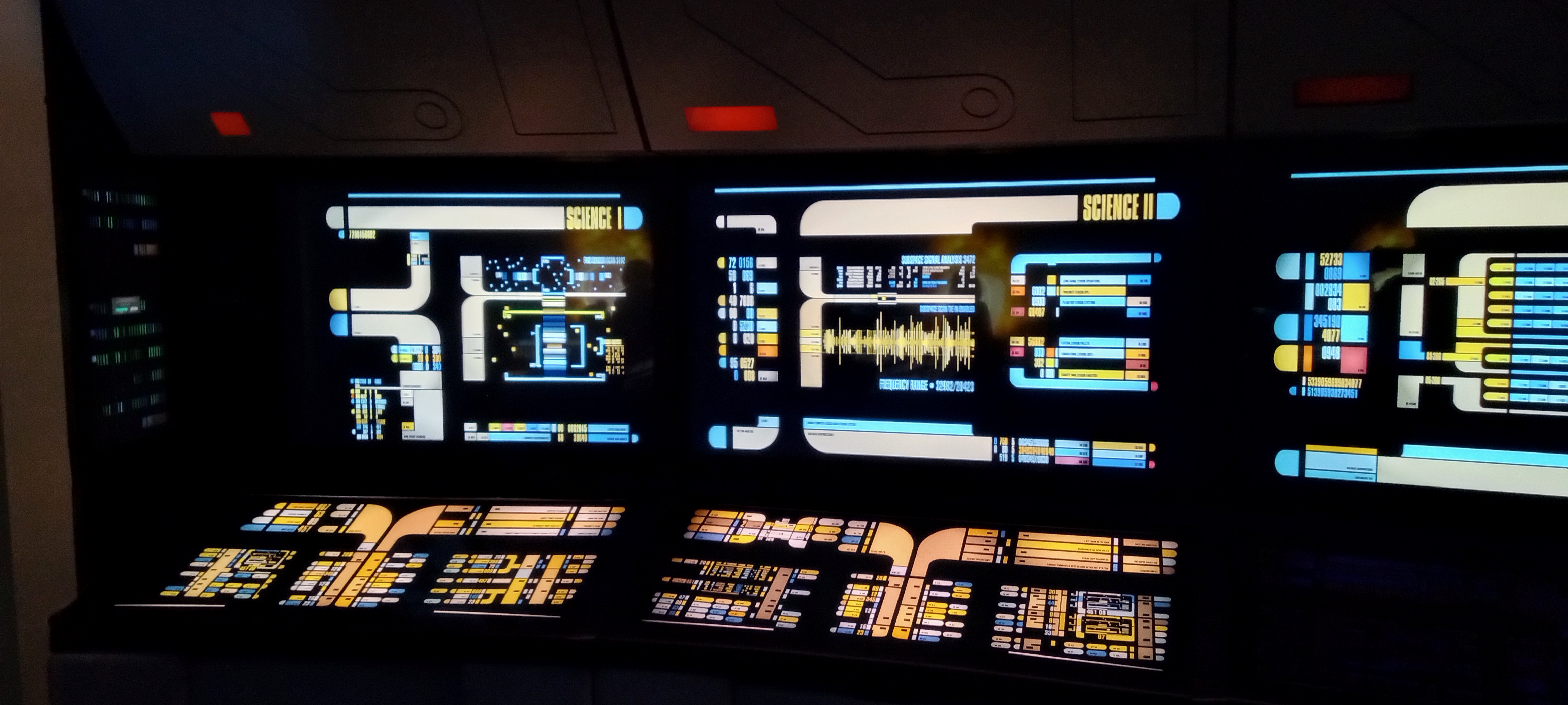 The aft science stations aboard the Enterprise-D lit with LCARS science displays.