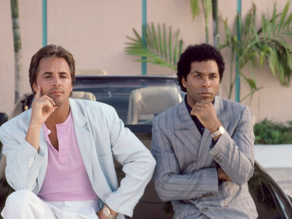 Don Johnson and Philip Michael Thomas in pale 1980s clothing during a Miami Vice publicity photograph.