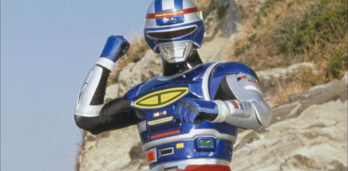 Space Sheriff Shaider posing in metallic blue and silver combat armour against rocks.