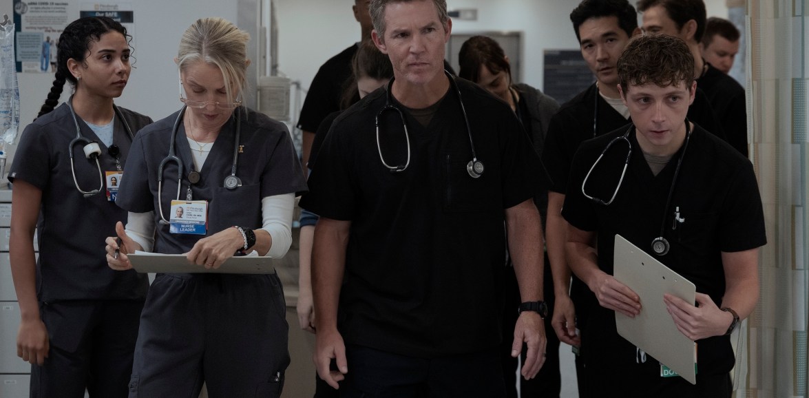 The Pitt season two night-shift handover, with Dana Evans and Dr Abbot leading clinicians through the hospital corridor.